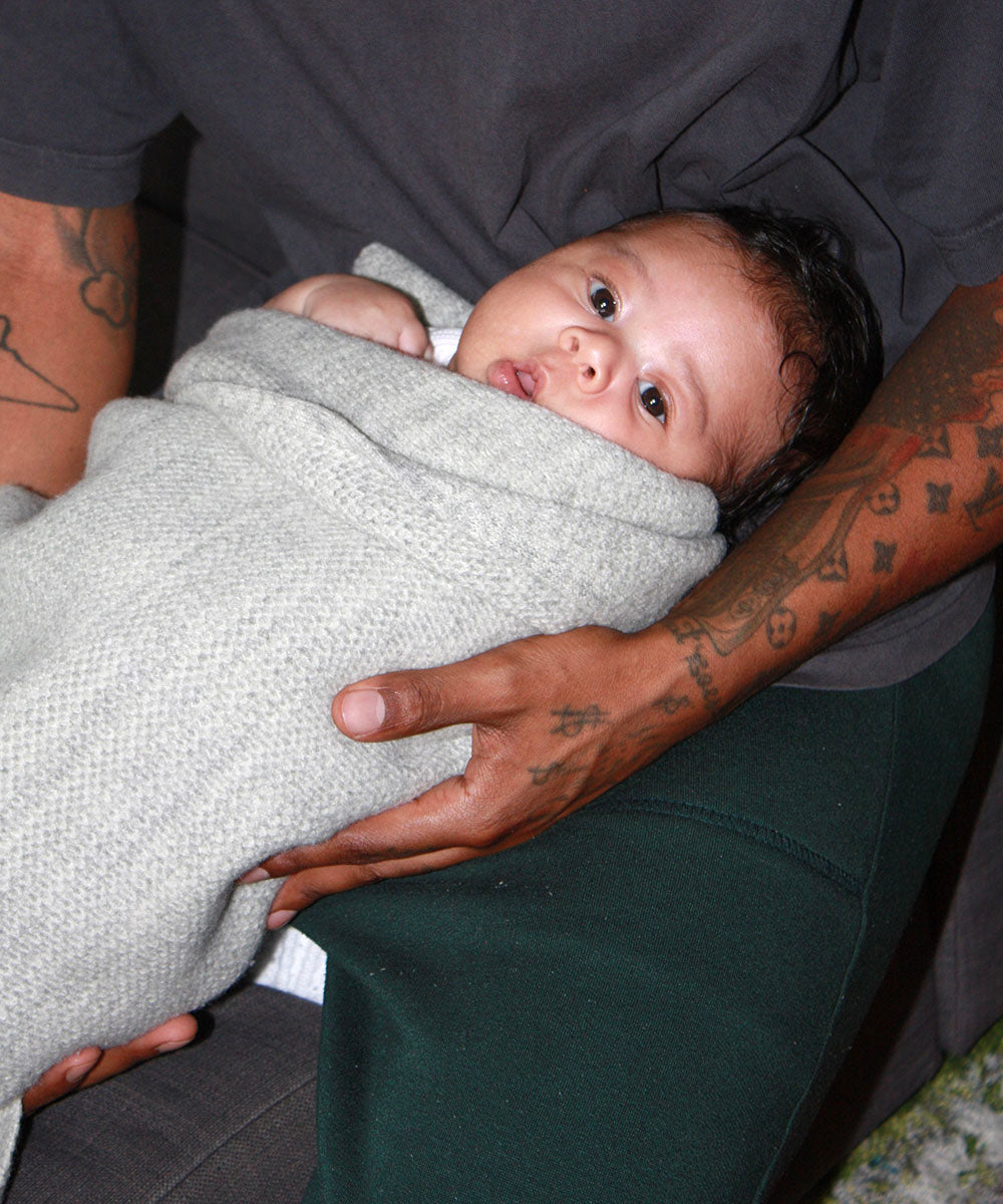 Baby wrapped in a grey organic merino AU Baby blanket