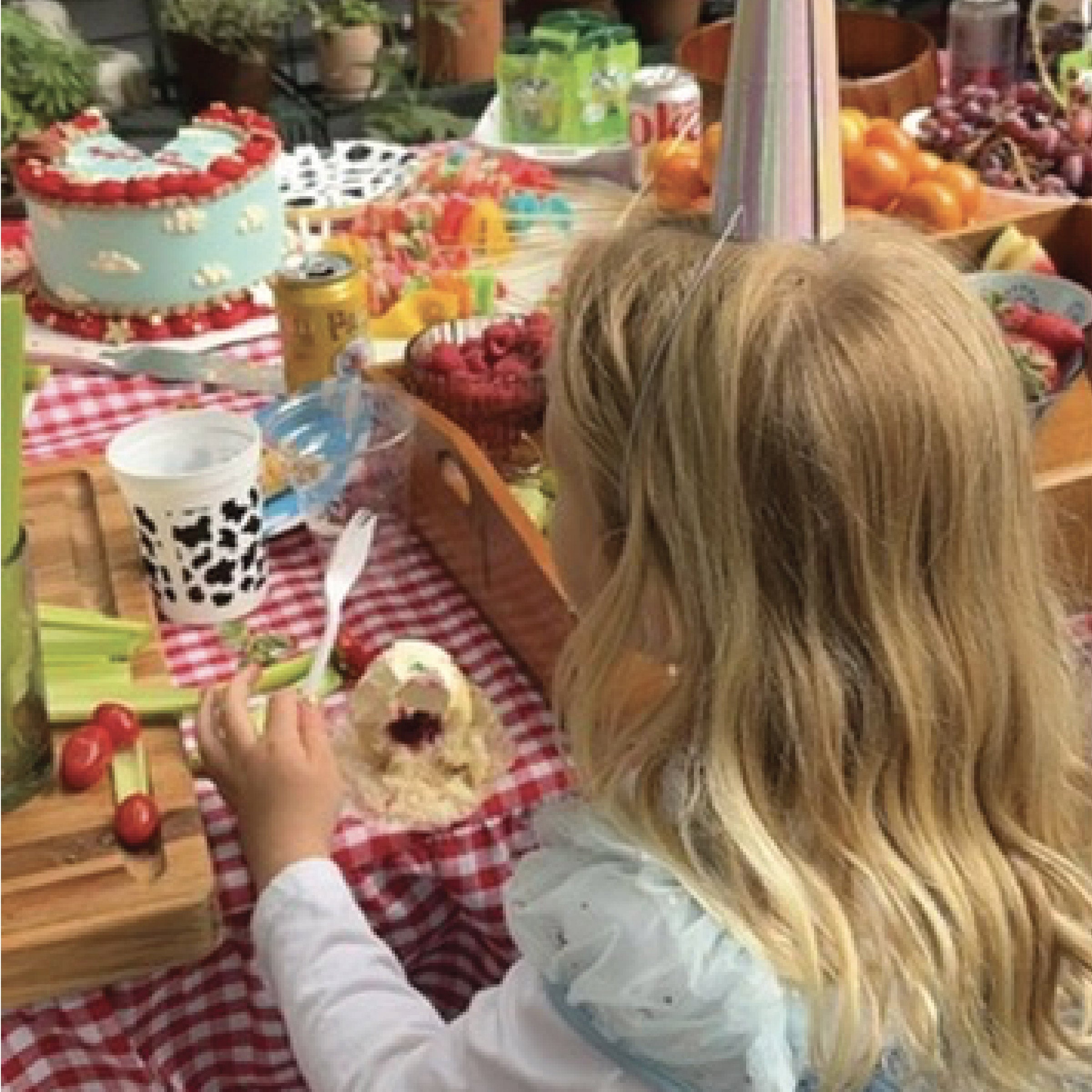 Little girl in a princess dress enjoying a birthday party.