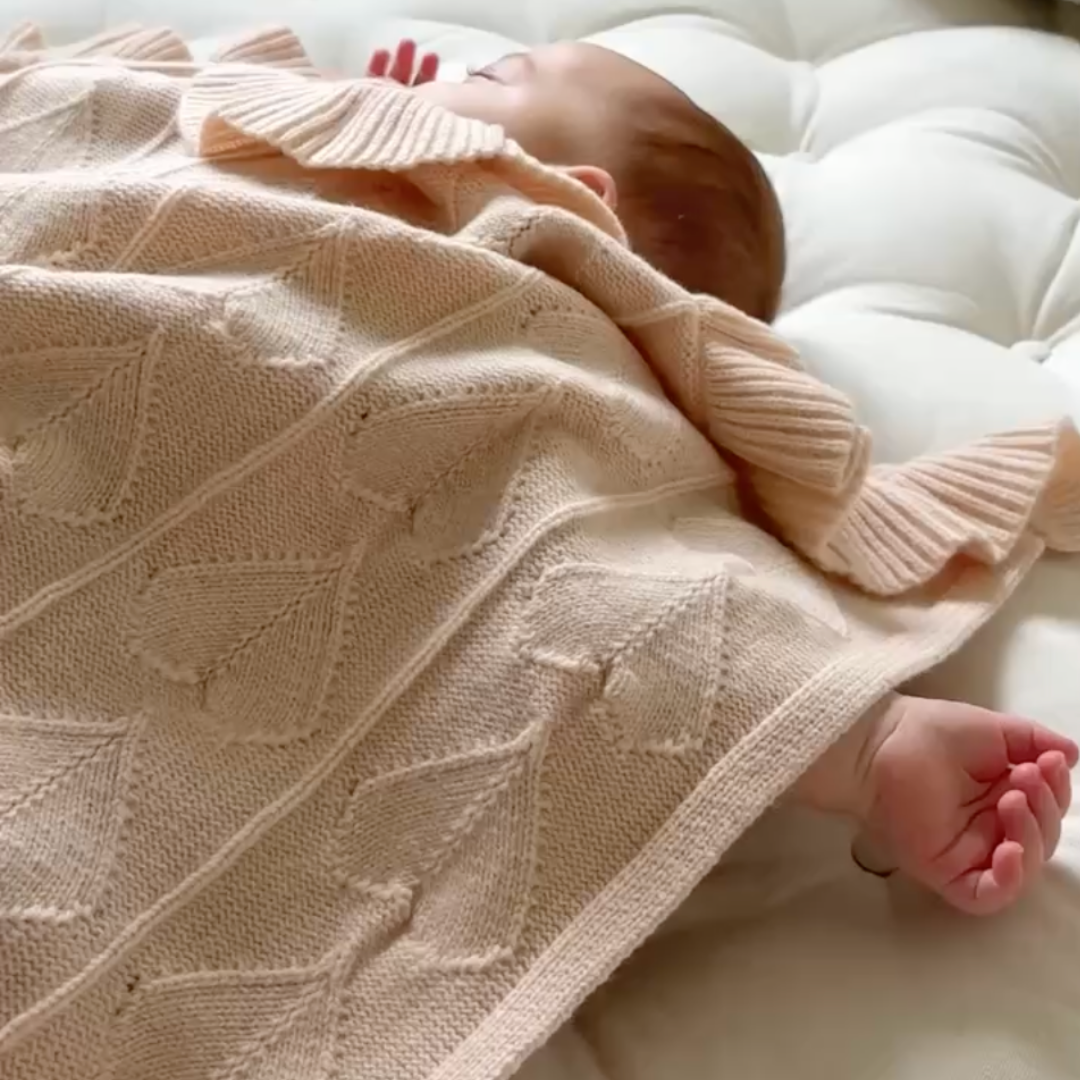 Baby sleeping peacefully in breathable blanket designed for sensitive skin and eczema support