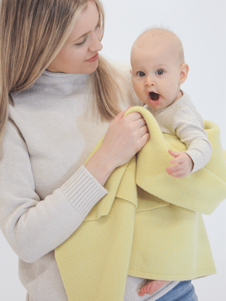 Mom and baby girl with AU Baby plant dyed merino Sawa blanket in Citron.