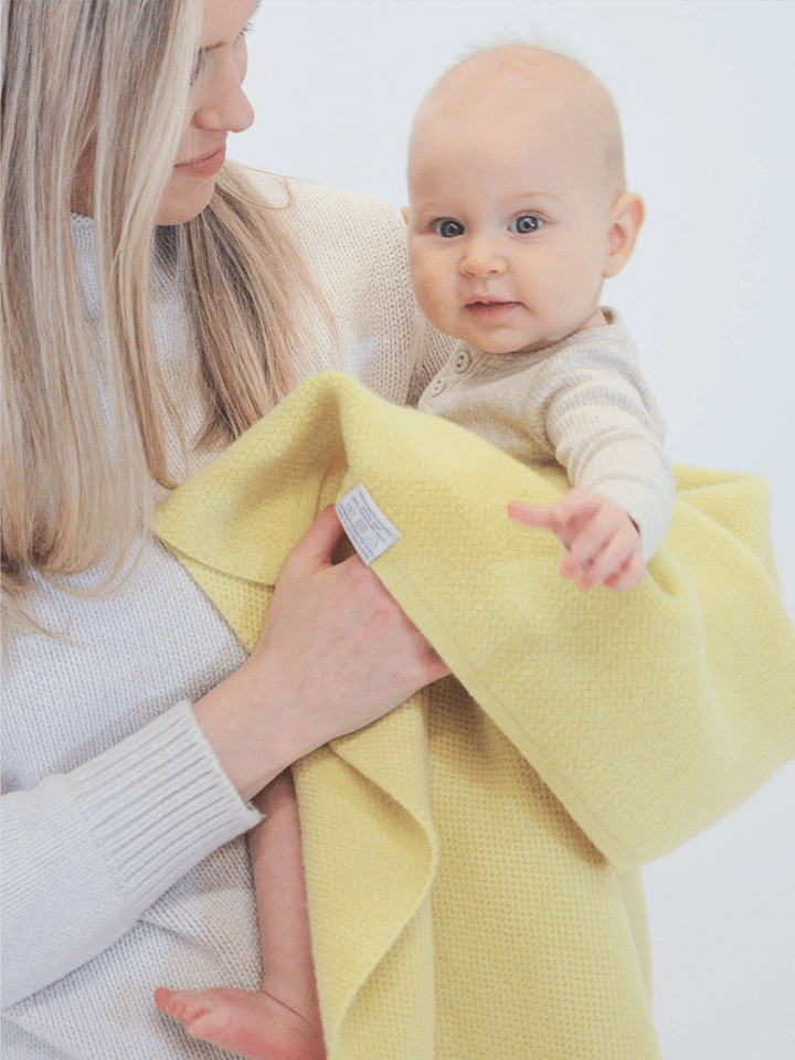 Mom and baby girl with AU Baby Sawa blanket in Citron.