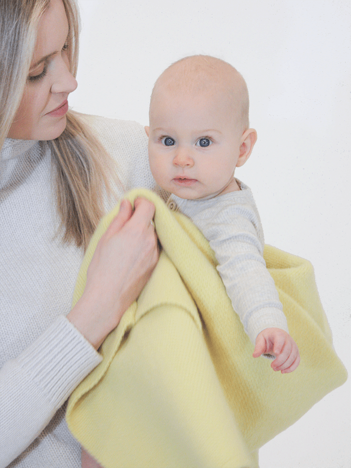 Mom and baby girl with AU Baby Sawa blanket in Citron.
